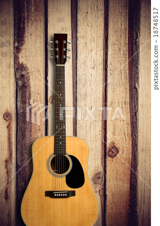 Acoustic guitar on wooden background 18748517