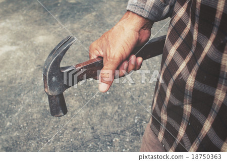 Man with hammer on hand 18750363