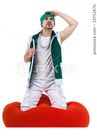 Surprised man dressed like a gnome sitting on red Surprised man dressed like a gnome sitting on red 18752670