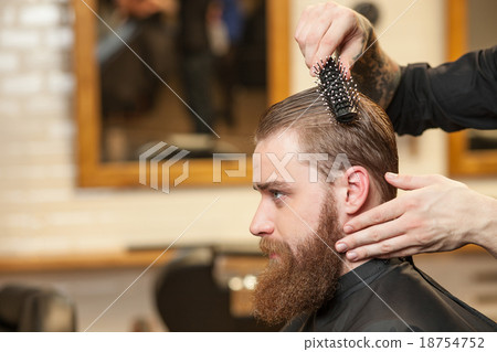 Attractive young bearded hipster attending the 18754752