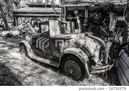Old rusted car in junk yard 18758379