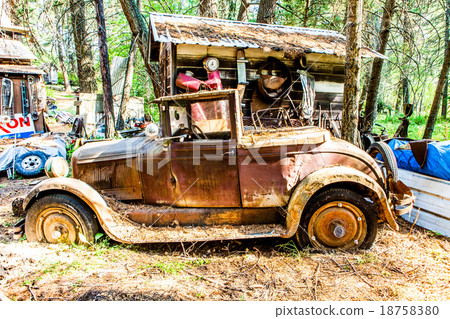 Old rusted car in junk yard 18758380
