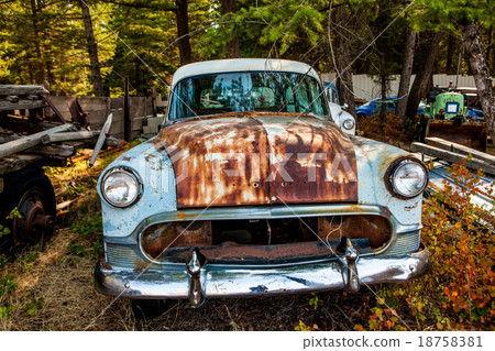 Old rusted car in junk yard 18758381