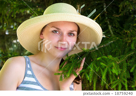 Young woman among fir trees Young woman among fir trees 18759240