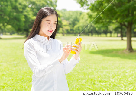 A woman watching a smartphone 18760486