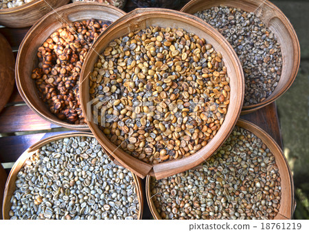 Various unroasted coffee beans on different bamboo 18761219
