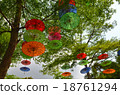 Colorful Umbrellas hanging on trees 18761294
