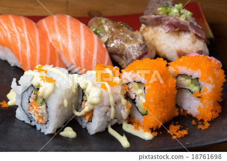 Japanese sushi roll served on a black plate Japanese sushi roll served on a black plate 18761698
