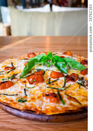 Traditional Italian pizza on wooden board 18762163