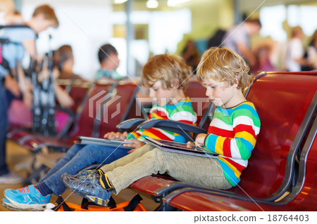 Two tired little sibling boys at the airport 18764403