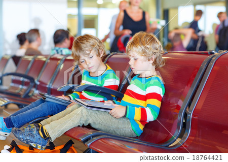 Two tired little sibling boys at the airport 18764421