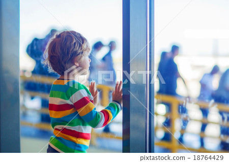 little tired kid boy at the airport, traveling 18764429
