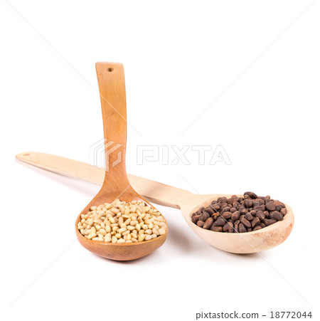 Pine nuts in a wooden spoon. Pine nuts in a wooden spoon. 18772044