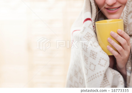 Cheerful sick girl is enjoying hot drink Cheerful sick girl is enjoying hot drink 18773335