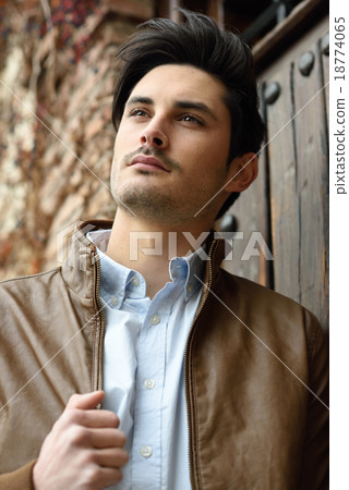 Attractive young handsome man, model of fashion in urban backgro Attractive young handsome man, model of fashion in urban backgro 18774065