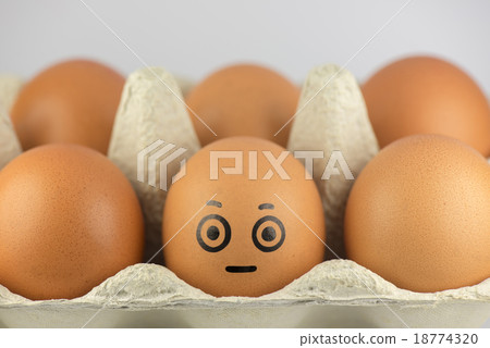 Egg with a face in a egg carton. Egg with a face in a egg carton. 18774320