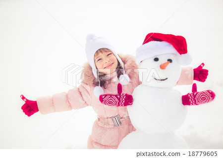 Child and snowman in winter Child and snowman in winter 18779605