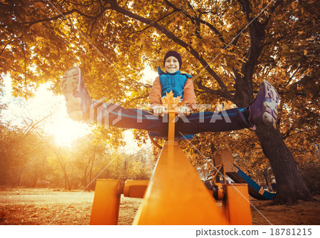 kid swinging at the park in autumn kid swinging at the park in autumn 18781215