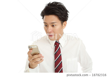 A young businessman looking at a smartphone 18782316