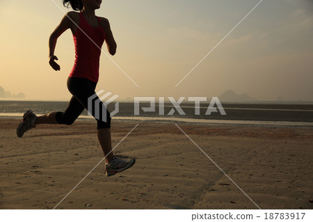 young woman running at sunrise beach 18783917
