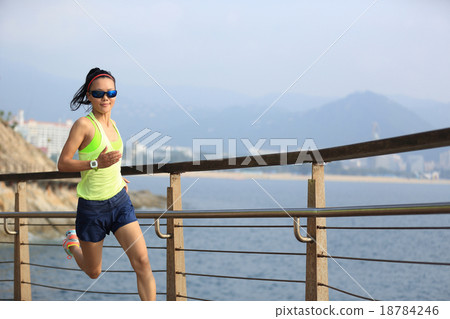 fitness woman running on wooden boardwalk seaside fitness woman running on wooden boardwalk seaside 18784246