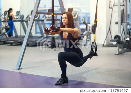 Athletic woman workout out squats weighted lunges 18791467