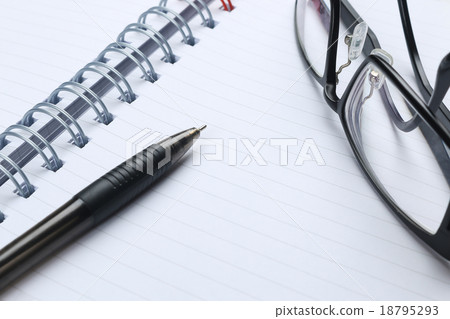 pen, notebook, glasses and financial report 18795293