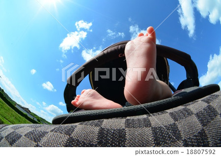 Baby's cute feet on a stroller Baby's cute feet on a stroller 18807592