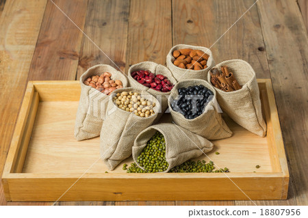 Different kinds of beans and cinnamon in sacks bag 18807956