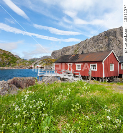 Typical red rorbu fishing hut in village Nusfjord 18811574