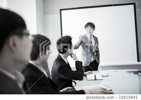businessman giving a presentation to his colleagues businessman giving a presentation to his colleagues 18815691