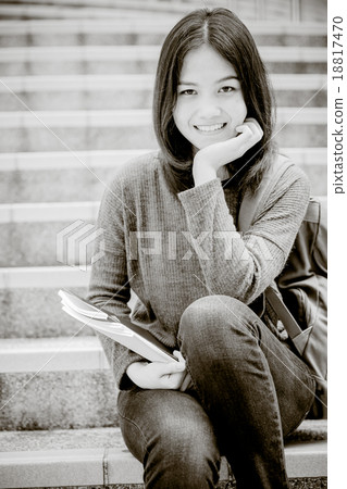 attractive female college student sitting on stairs 18817470