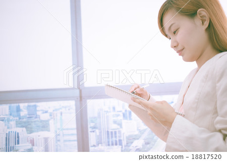Woman taking notes during business meeting in the office. Woman taking notes during business meeting in the office. 18817520
