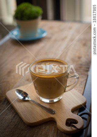 Hot art Latte Coffee in a cup on wooden table and Coffee shop bl Hot art Latte Coffee in a cup on wooden table and Coffee shop bl 18817805
