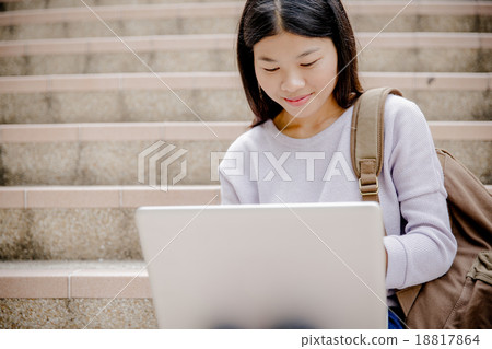 Young woman using laptop on steps outdoors Young woman using laptop on steps outdoors 18817864