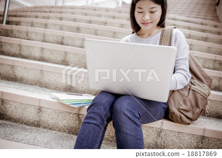 Young woman using laptop on steps outdoors Young woman using laptop on steps outdoors 18817869