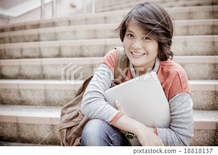 Young woman using laptop on steps outdoors Young woman using laptop on steps outdoors 18818137