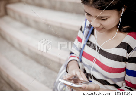 attractive female college student sitting on stairs attractive female college student sitting on stairs 18818143
