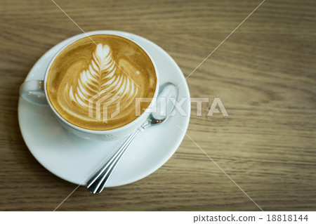 Hot latte art coffee cup on wooden table, vintage and retro styl Hot latte art coffee cup on wooden table, vintage and retro styl 18818144