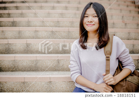attractive female college student sitting on stairs attractive female college student sitting on stairs 18818151