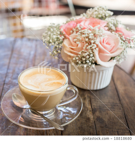 hot coffee and bouquet of flower on grunge wood table hot coffee and bouquet of flower on grunge wood table 18818680
