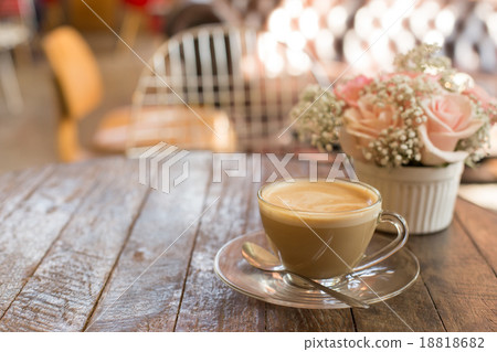 hot coffee and bouquet of flower on grunge wood table hot coffee and bouquet of flower on grunge wood table 18818682