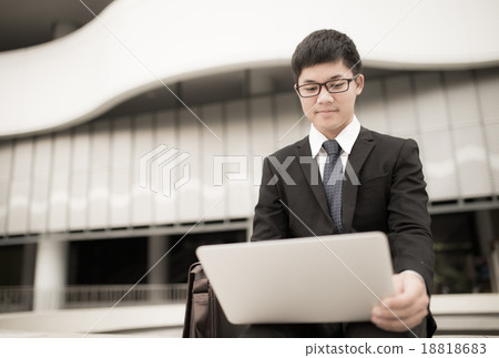 Portrait of a handsome young man on laptop outdoors Portrait of a handsome young man on laptop outdoors 18818683