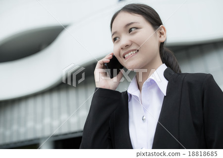Young businesswoman using mobile phone Young businesswoman using mobile phone 18818685