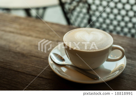Hot art Latte Coffee in a cup on wooden table and Coffee shop bl Hot art Latte Coffee in a cup on wooden table and Coffee shop bl 18818991