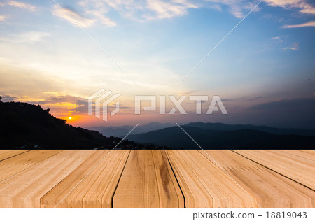 Close up top of old wooden table with blur sunset background Close up top of old wooden table with blur sunset background 18819043