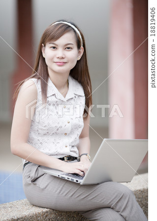Beautiful young woman using laptop Beautiful young woman using laptop 18819406