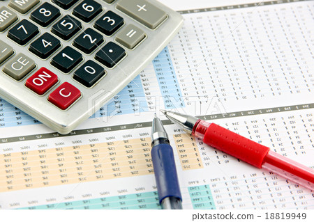 Pen and Calculator that is placed on businesses graph. Pen and Calculator that is placed on businesses graph. 18819949