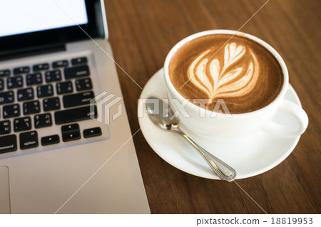 Hot art Latte Coffee in a cup and laptop on wooden table in Coff Hot art Latte Coffee in a cup and laptop on wooden table in Coff 18819953