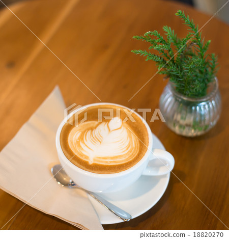 Hot art Latte Coffee in a cup on wooden table Hot art Latte Coffee in a cup on wooden table 18820270
